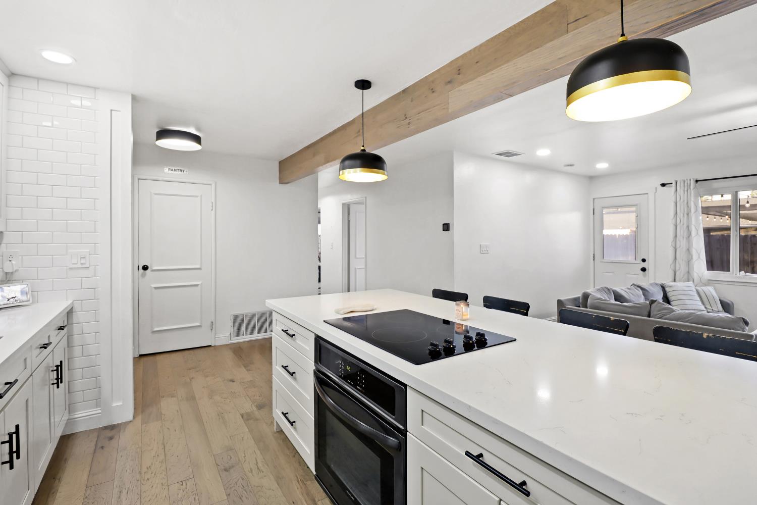 5208 Rambler Way Sacramento, CA 95841 - Photo 28 of 51 a kitchen with a sink a stove and cabinets