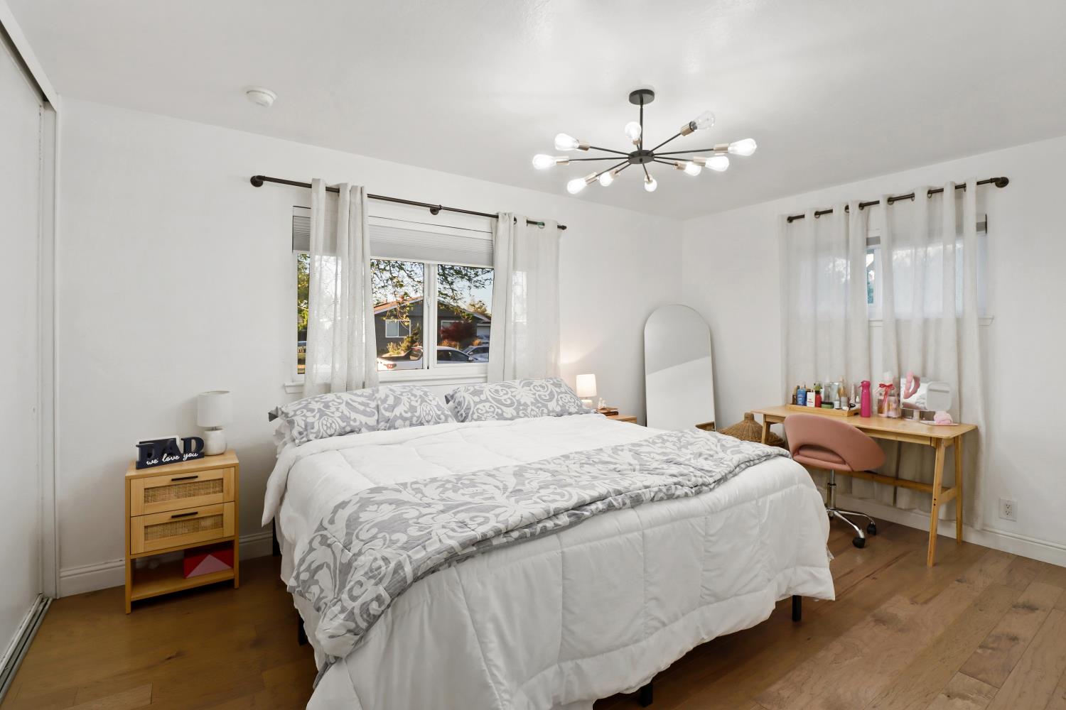 5208 Rambler Way Sacramento, CA 95841 - Photo 30 of 51 a bedroom with a bed and a chandelier