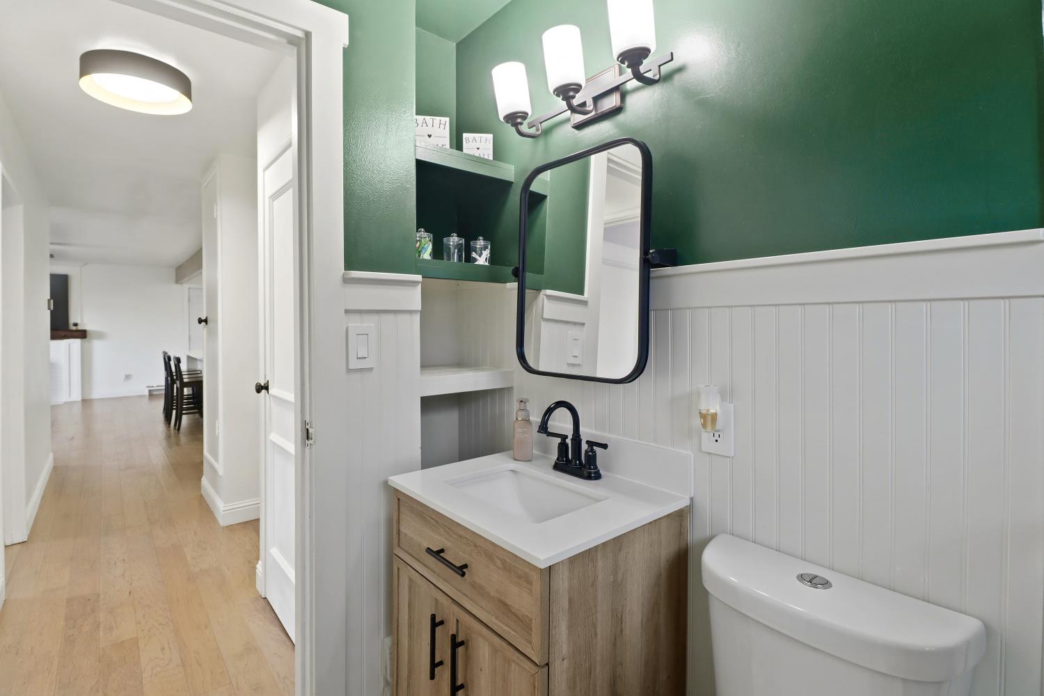 5208 Rambler Way Sacramento, CA 95841 - Photo 38 of 51 a bathroom with a toilet sink and mirror
