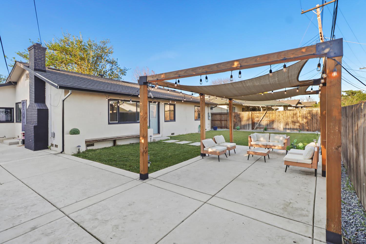 5208 Rambler Way Sacramento, CA 95841 - Photo 47 of 51 a view of a patio with a table and chairs under an umbrella