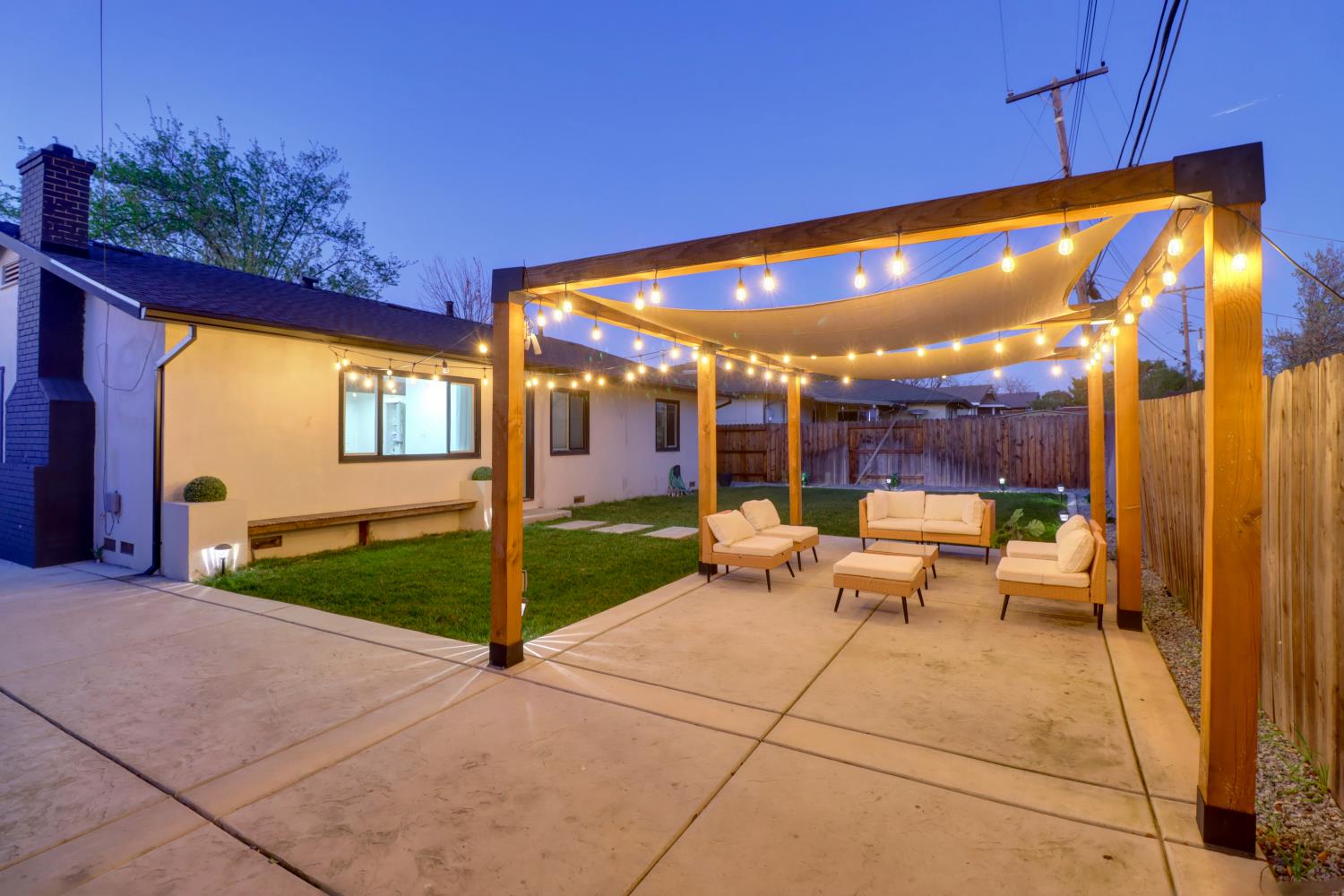 5208 Rambler Way Sacramento, CA 95841 - Photo 5 of 51 a view of a patio with a table and chairs under an umbrella