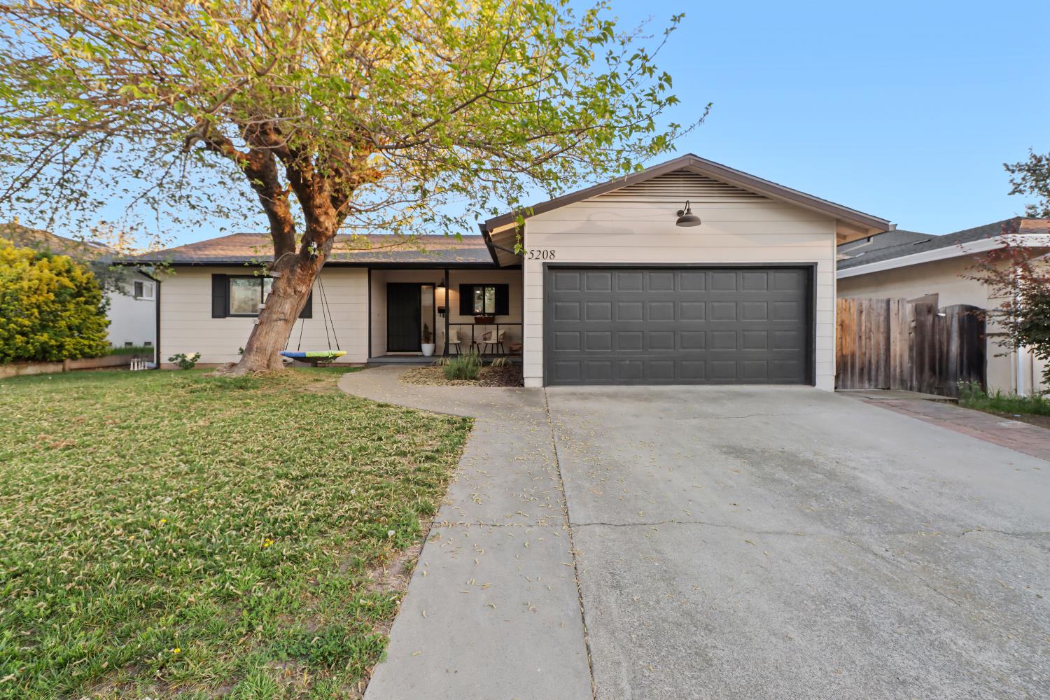 5208 Rambler Way Sacramento, CA 95841 - Photo 51 of 51 a front view of a house with a yard and garage