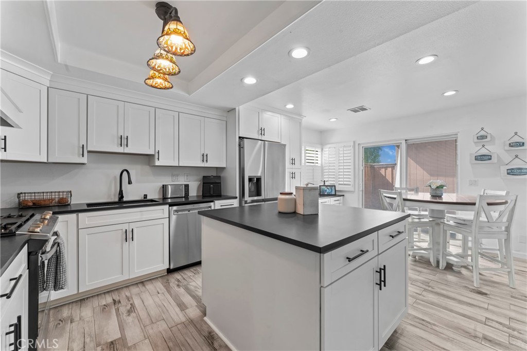 14456 Foothill, Unit 47 Sylmar, CA 91342 - Photo 11 of 26 a kitchen with a sink cabinets and wooden floor