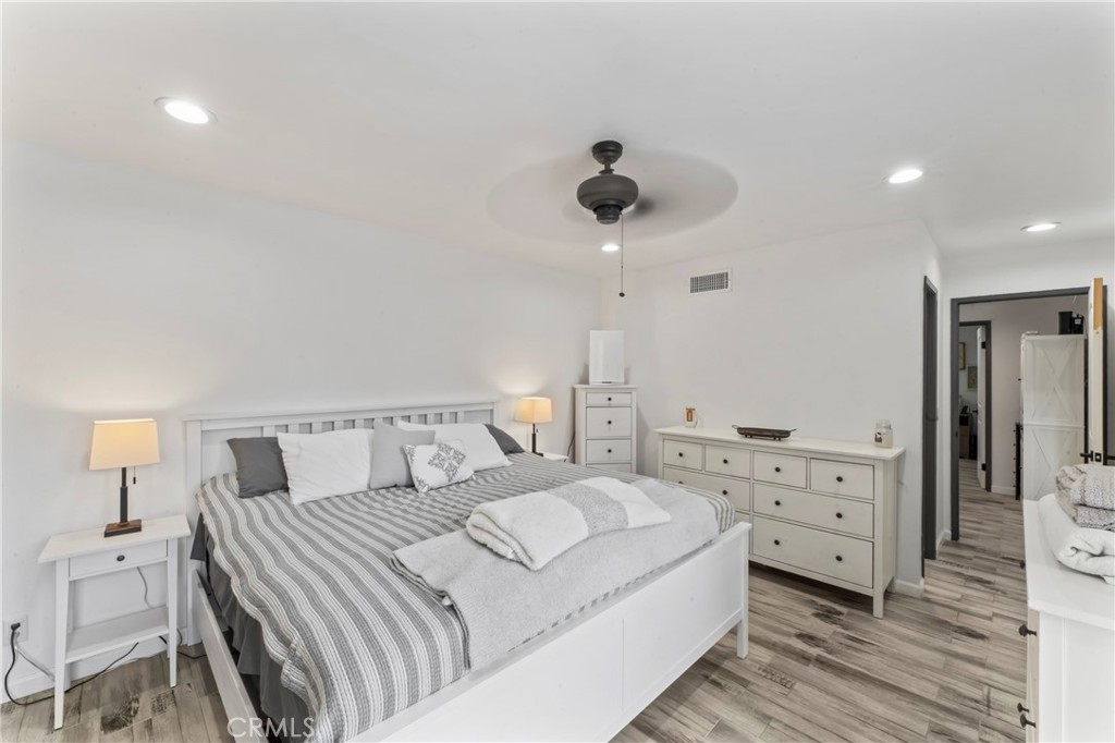 14456 Foothill, Unit 47 Sylmar, CA 91342 - Photo 14 of 26 a bedroom with a bed and a chandelier