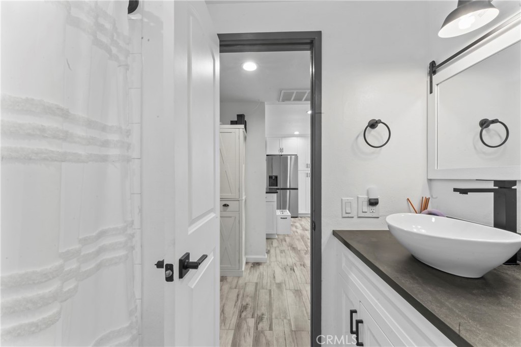 14456 Foothill, Unit 47 Sylmar, CA 91342 - Photo 18 of 26 a bathroom with a toilet a sink and mirror