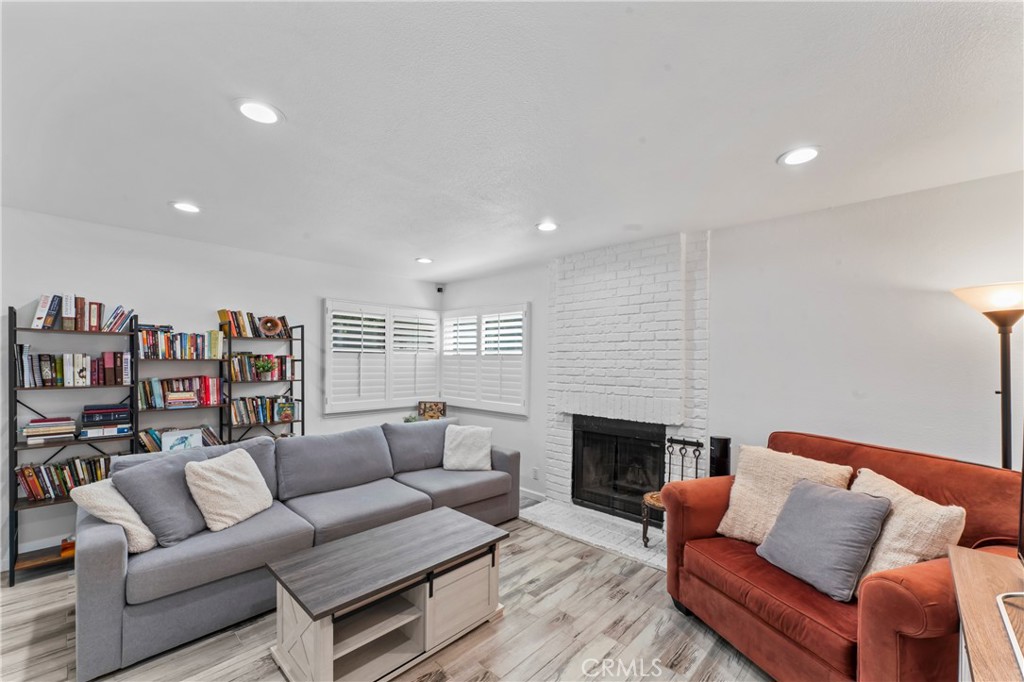 14456 Foothill, Unit 47 Sylmar, CA 91342 - Photo 7 of 26 a living room with furniture and a fireplace