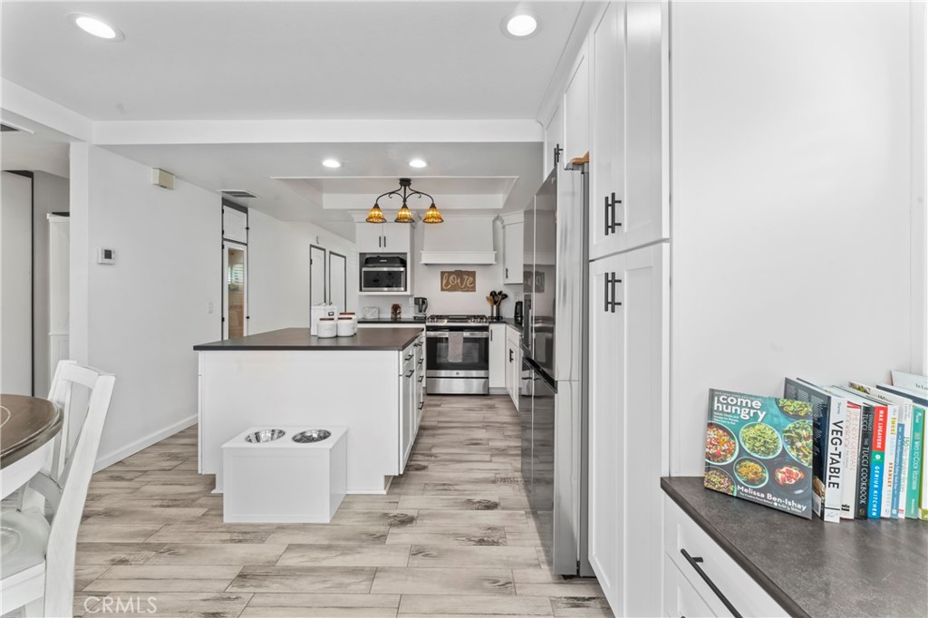 14456 Foothill, Unit 47 Sylmar, CA 91342 - Photo 9 of 26 a living room with stainless steel appliances kitchen island granite countertop a refrigerator and a stove