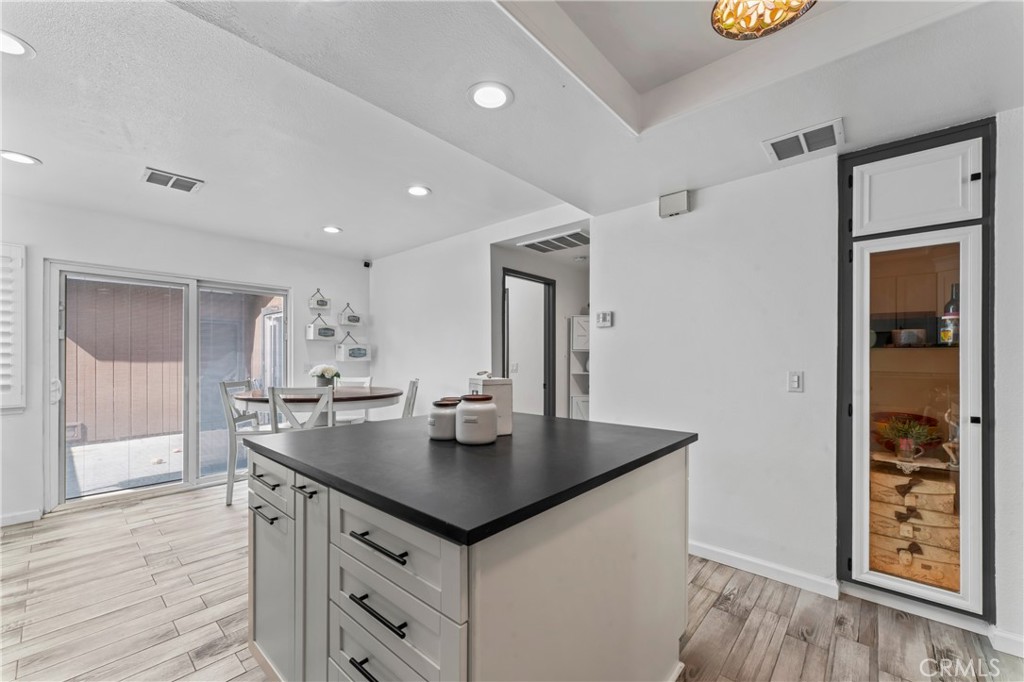 14456 Foothill, Unit 47 Sylmar, CA 91342 - Photo 10 of 26 a view of kitchen island sink refrigerator and microwave