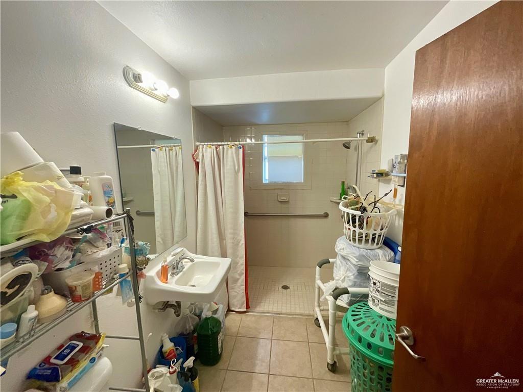 5146 Jm Martinez Street, Unit J Rio Grande City, TX 78582 - Photo 8 of 13 a bathroom with a sink mirror and shower
