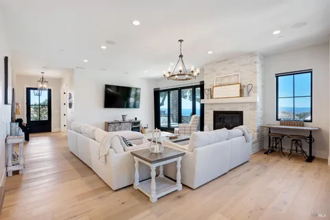 a living room with couch and a floor to ceiling window