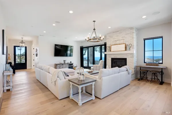 a living room with couch and a floor to ceiling window