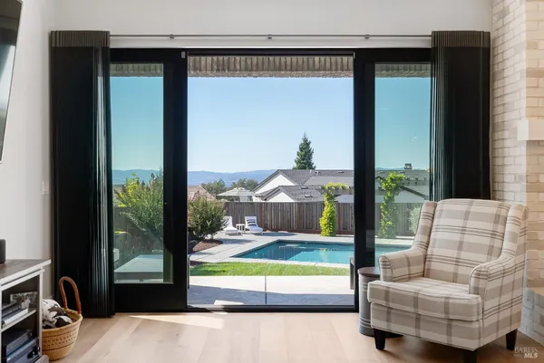 a kitchen with stainless steel appliances granite countertop a stove a sink dishwasher and a refrigerator with wooden floor