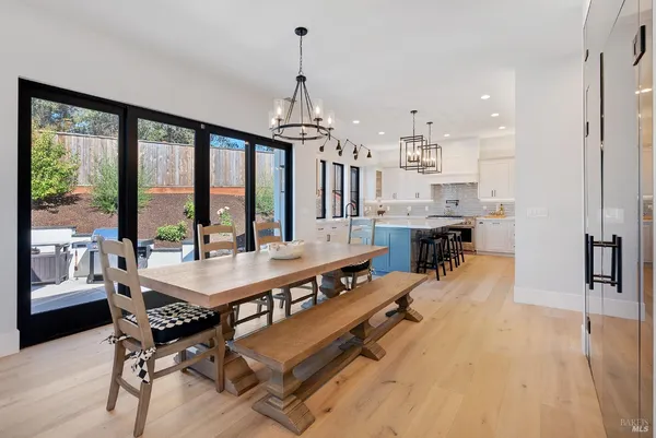 a kitchen that has a sink a stove and cabinets