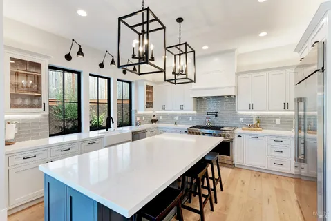a kitchen with stainless steel appliances granite countertop a stove a sink and a refrigerator