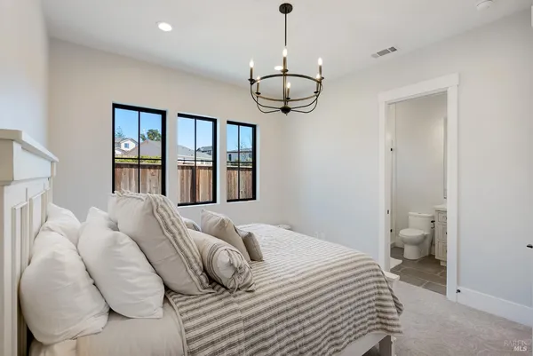 a large bedroom with a large window and a bed