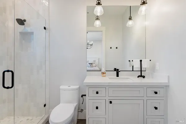 a bedroom with a bed and glass window