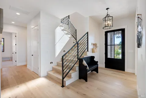 a spacious bedroom with a bed and a flat screen tv