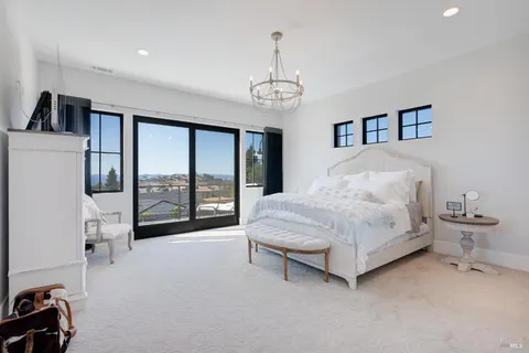 a view of patio with chairs and table under an umbrella