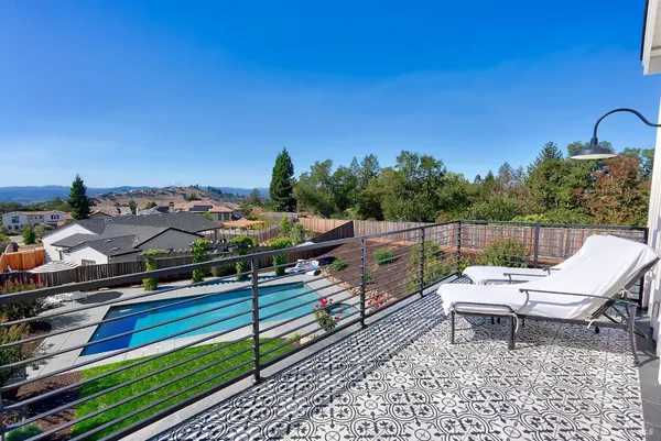 a view of a porch with a couch and a floor to ceiling window