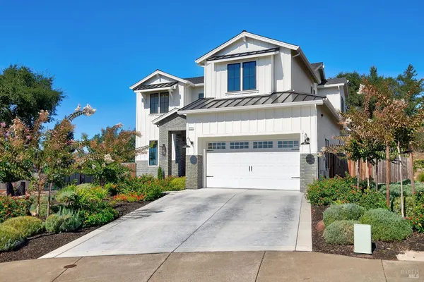 a view of a brick house with large windows