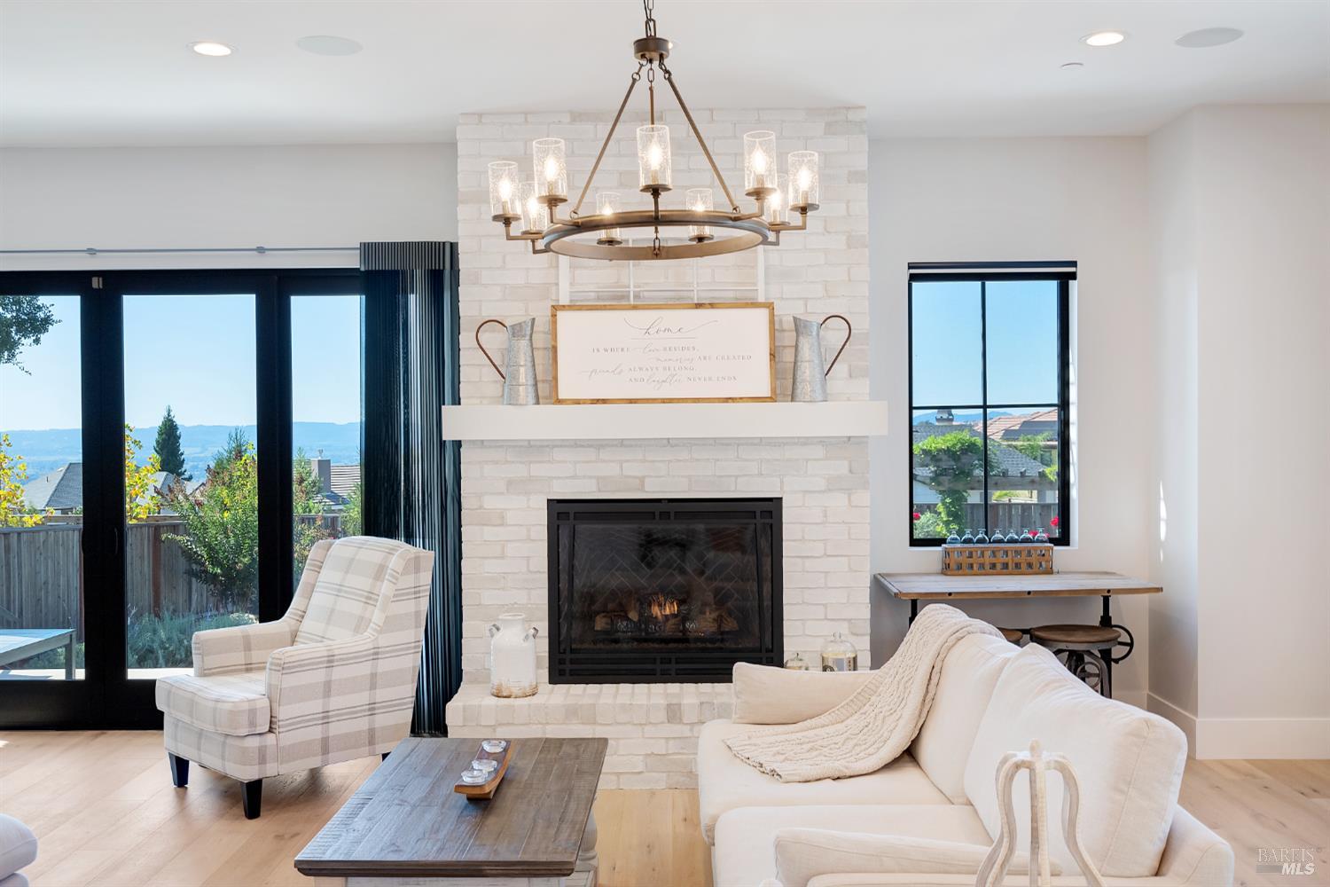 3724 Stanhope Court Santa Rosa, CA 95404 - Photo 10 of 78 a living room with furniture a fireplace and a chandelier