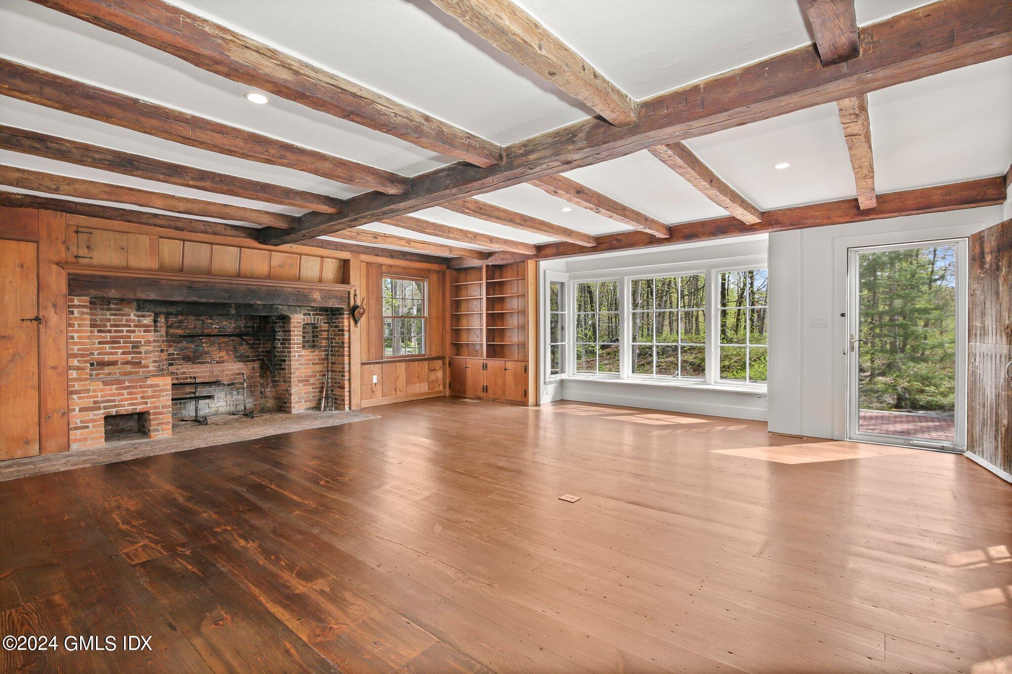 69 Clapboard Ridge Road Greenwich, CT 06830 - Photo 13 of 40 a view of an empty room with wooden floor and a window