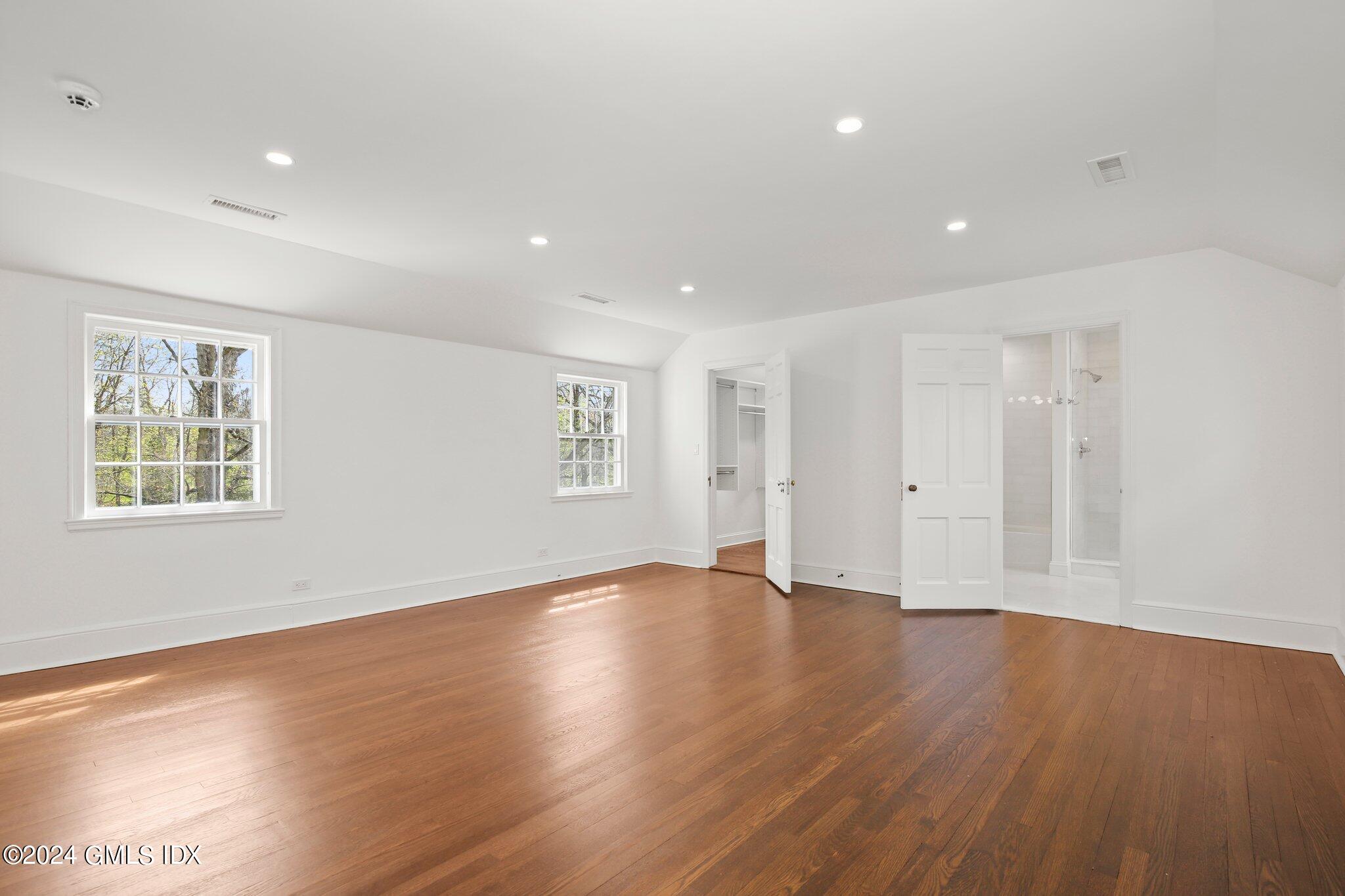 69 Clapboard Ridge Road Greenwich, CT 06830 - Photo 19 of 40 a view of an empty room with wooden floor and a window