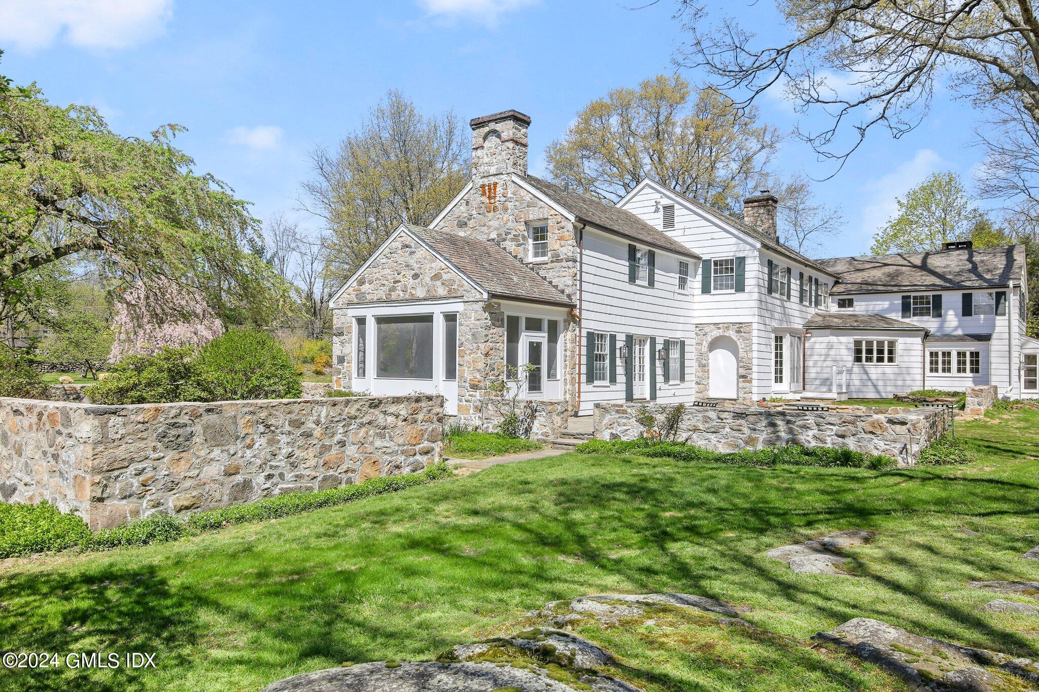 69 Clapboard Ridge Road Greenwich, CT 06830 - Photo 3 of 40 front view of a house with a yard
