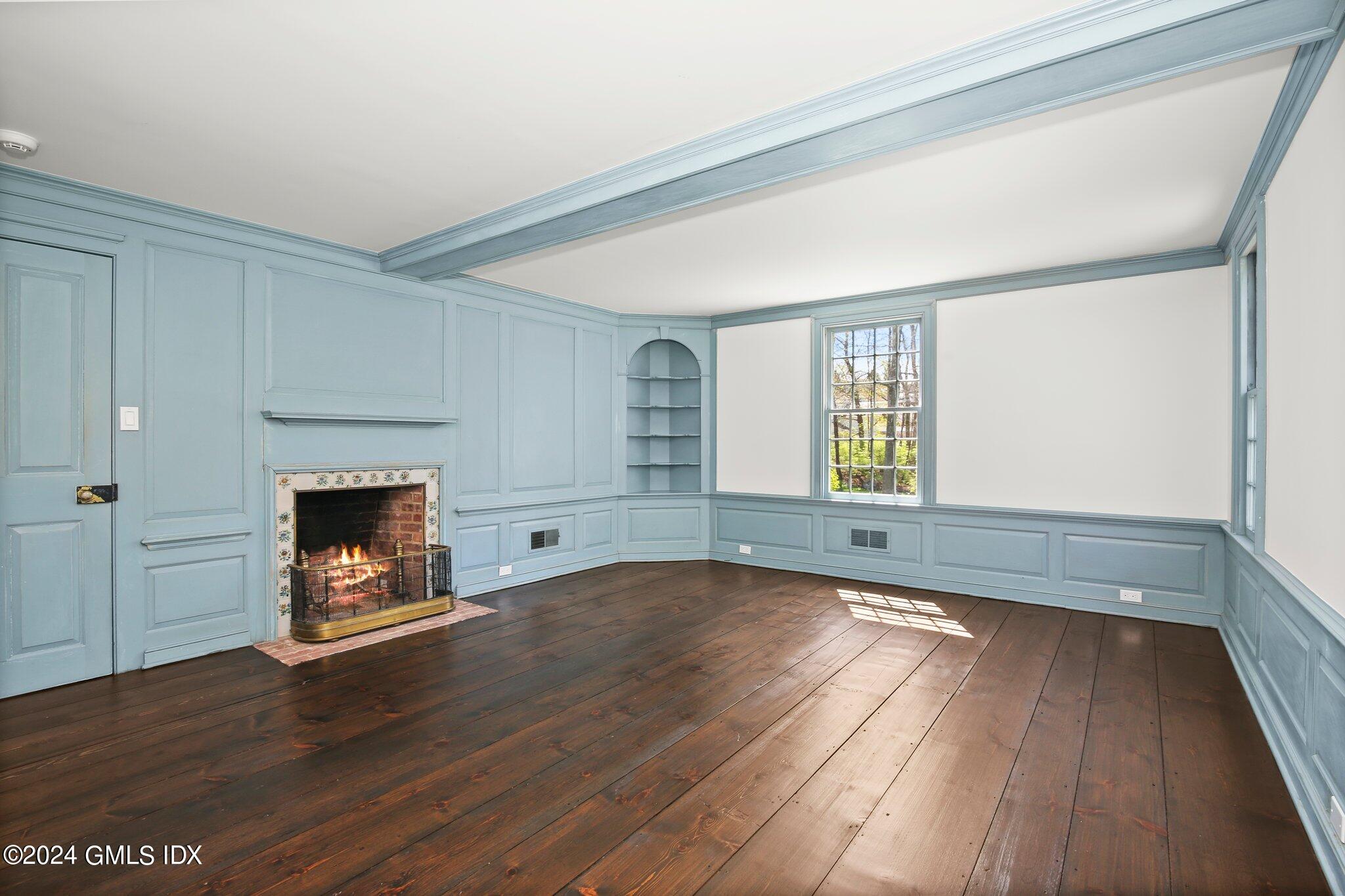 69 Clapboard Ridge Road Greenwich, CT 06830 - Photo 32 of 40 a view of an empty room with wooden floor fireplace and a window