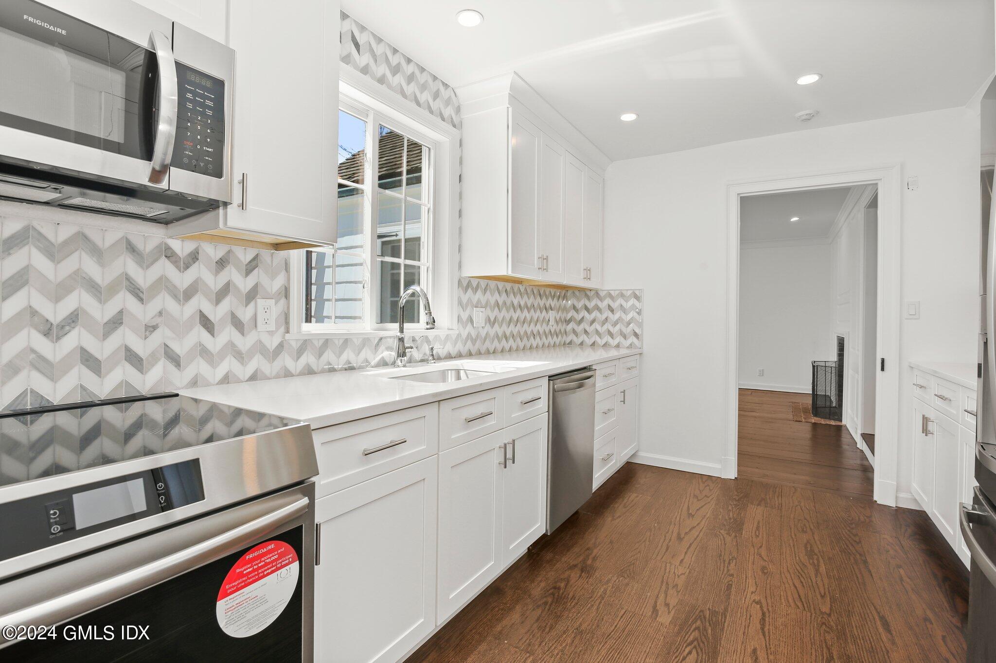 69 Clapboard Ridge Road Greenwich, CT 06830 - Photo 34 of 40 a spacious bathroom with a granite countertop sink and a mirror