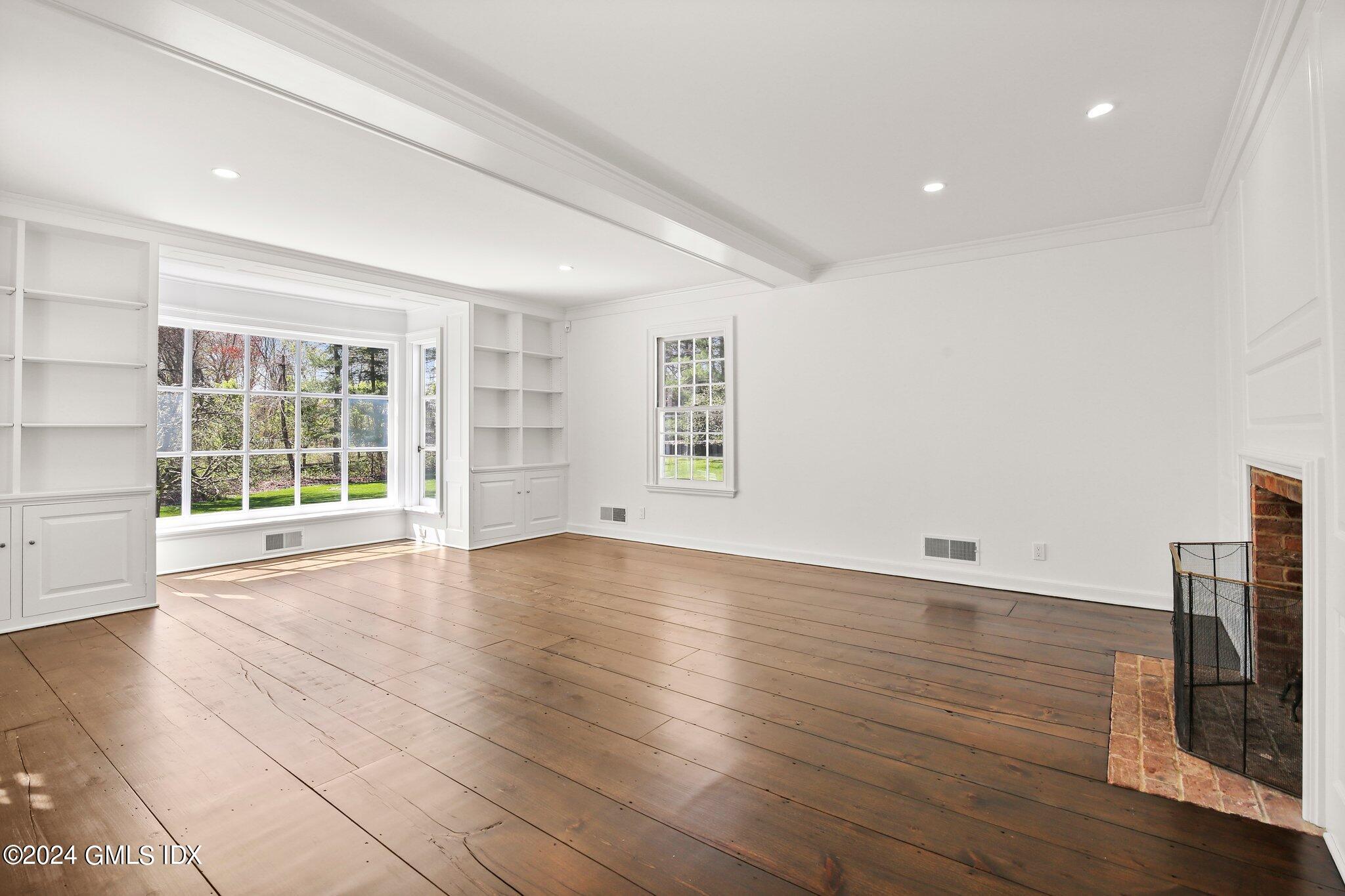 69 Clapboard Ridge Road Greenwich, CT 06830 - Photo 35 of 40 an empty room with wooden floor and windows