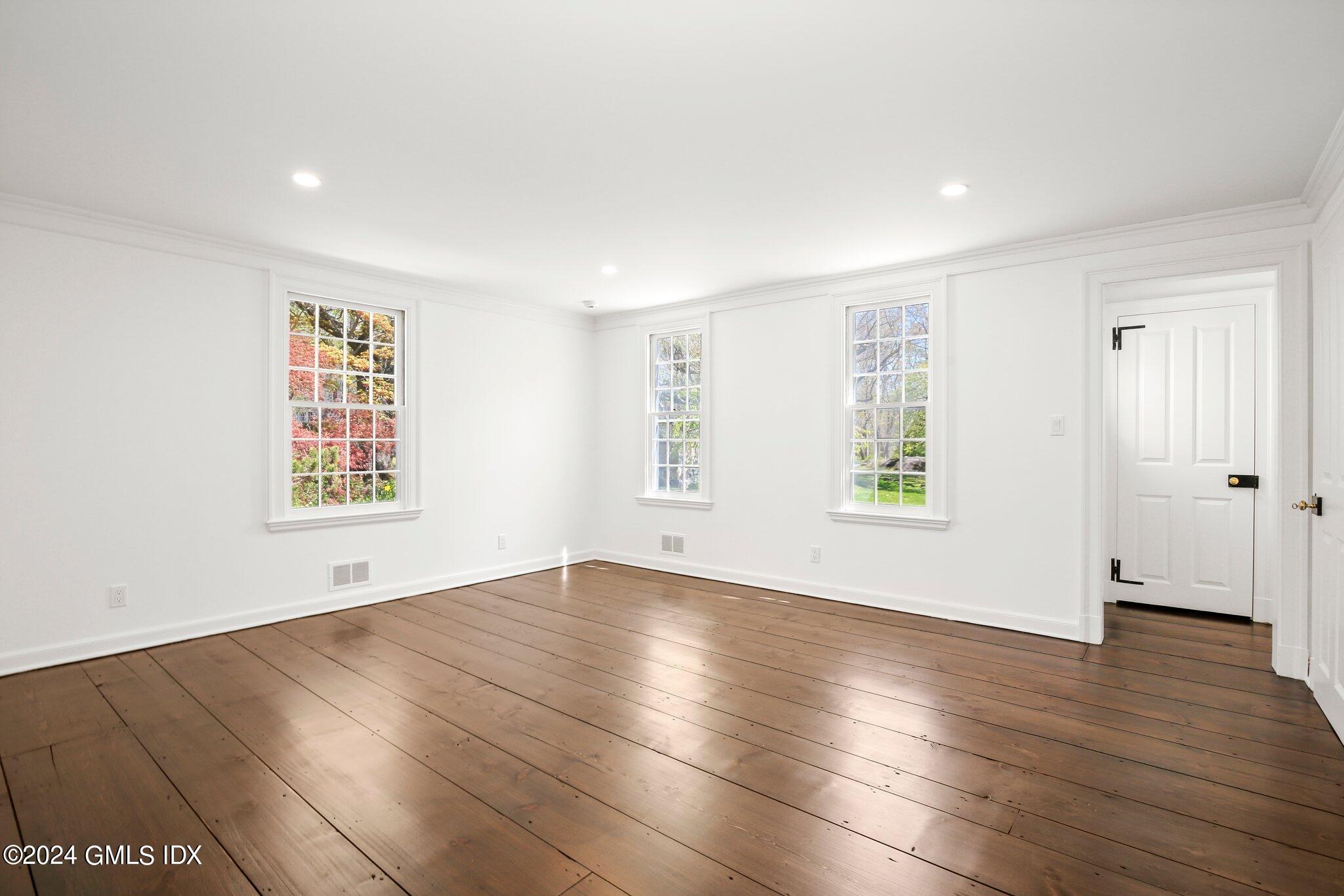 69 Clapboard Ridge Road Greenwich, CT 06830 - Photo 36 of 40 an empty room with wooden floor and windows