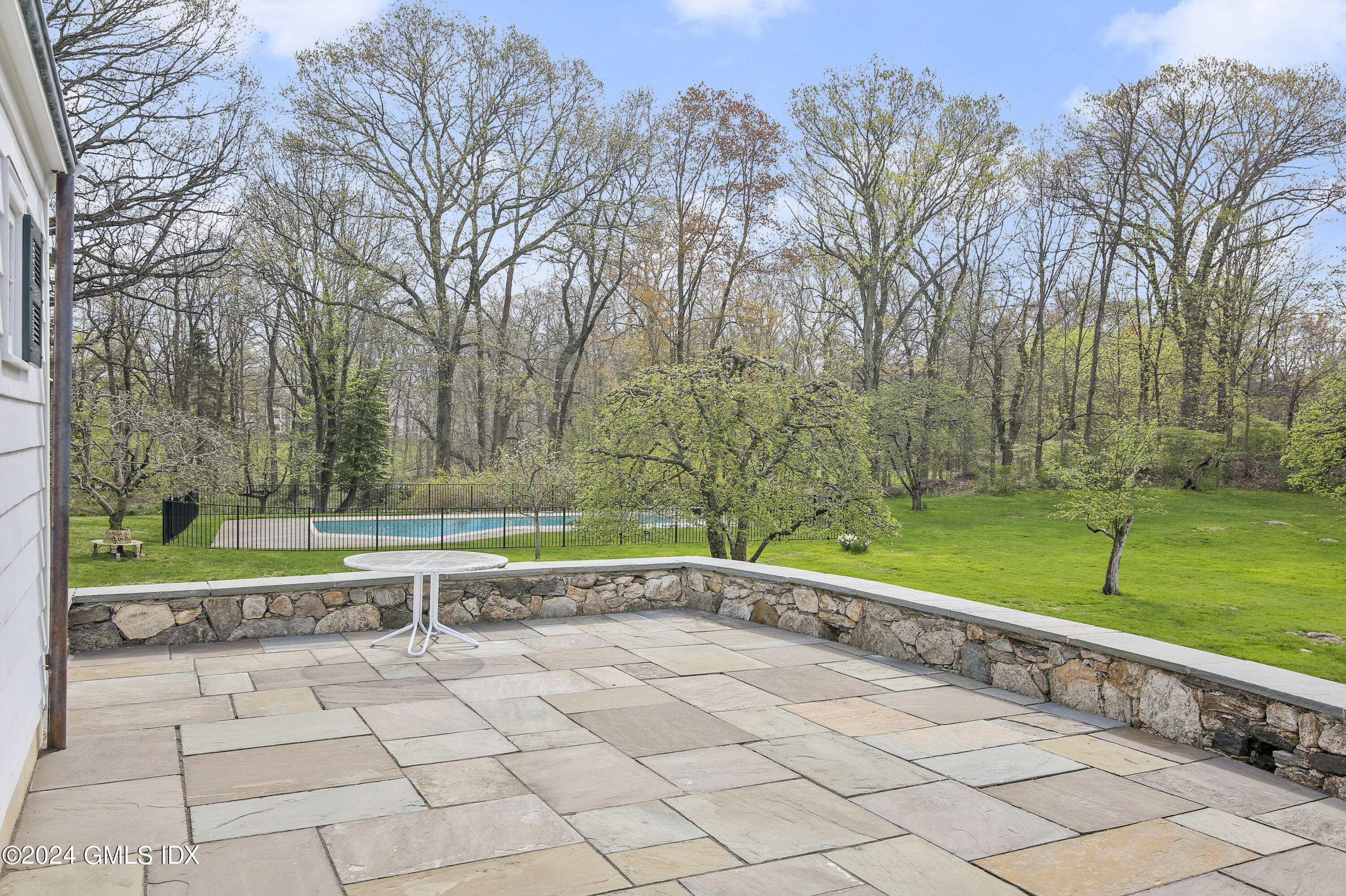 69 Clapboard Ridge Road Greenwich, CT 06830 - Photo 38 of 40 a view of a yard with a bench and trees