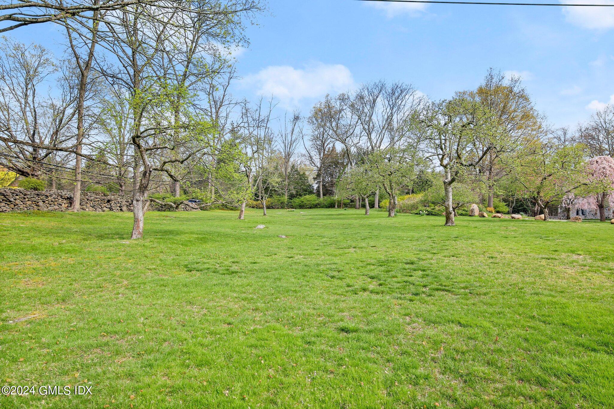 69 Clapboard Ridge Road Greenwich, CT 06830 - Photo 4 of 40 a backyard of apartments with large trees