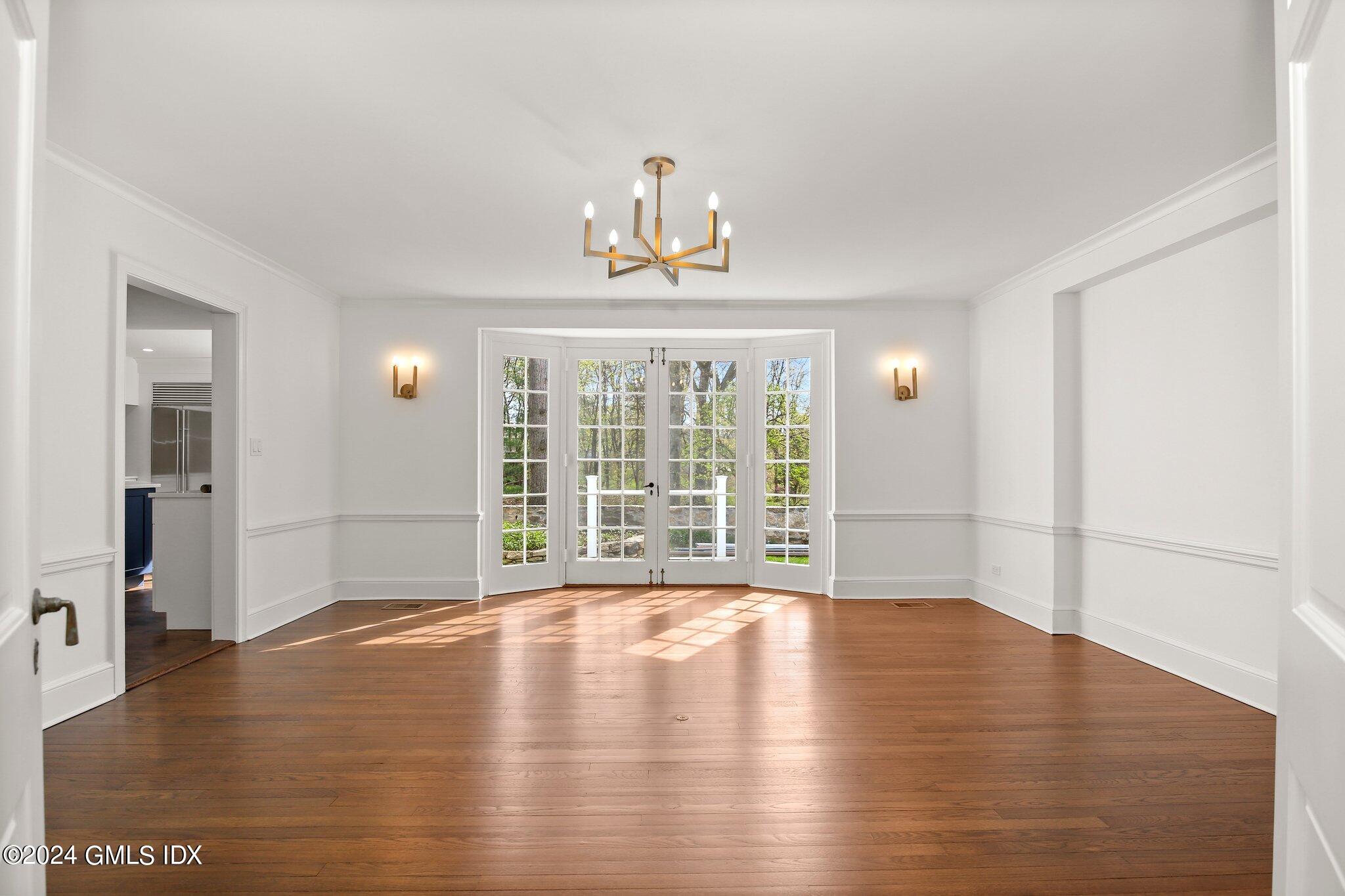 69 Clapboard Ridge Road Greenwich, CT 06830 - Photo 8 of 40 a view of an empty room with wooden floor and a window