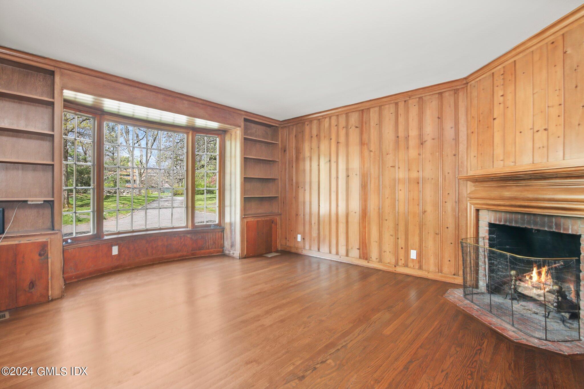 69 Clapboard Ridge Road Greenwich, CT 06830 - Photo 9 of 40 wooden floor fireplace and windows in an empty room