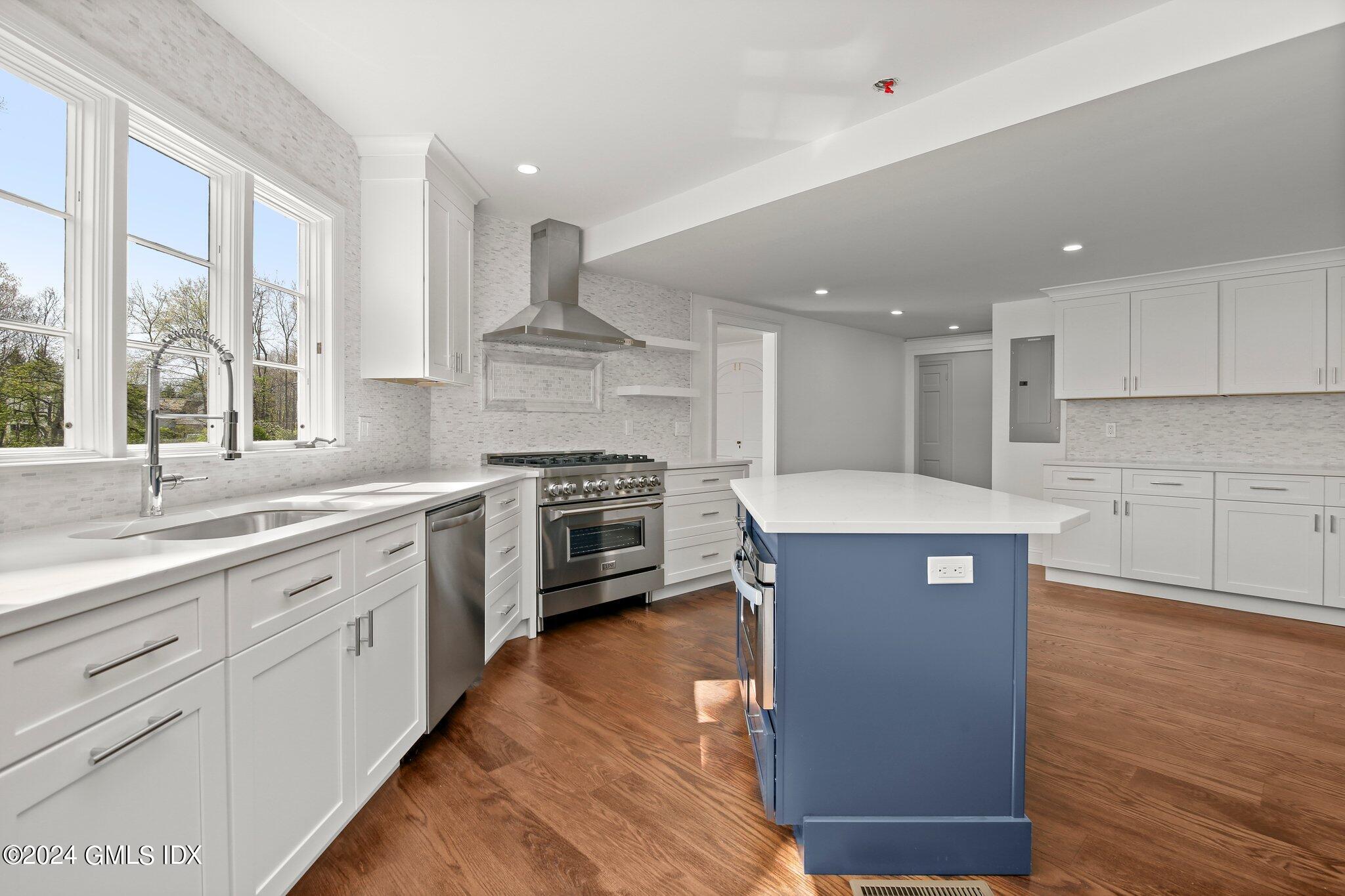 69 Clapboard Ridge Road Greenwich, CT 06830 - Photo 10 of 40 a kitchen with stainless steel appliances kitchen island granite countertop a stove a sink and a refrigerator