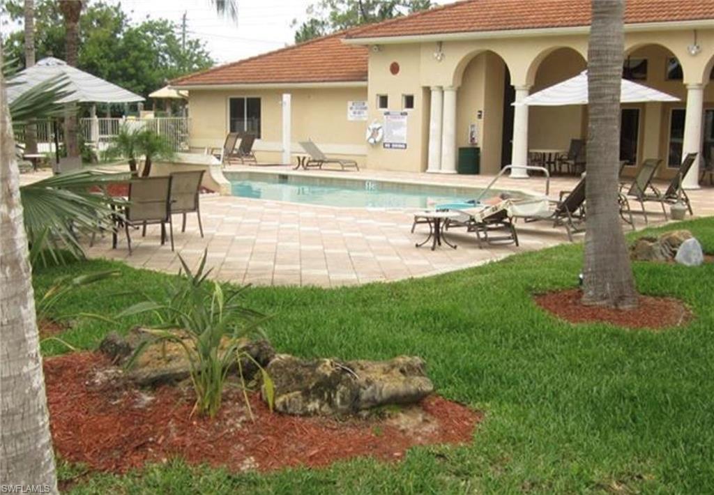 8255 Ibis Club Drive, Unit 504 Naples, FL 34104 - Photo 2 of 4 a view of a house with backyard porch and patio