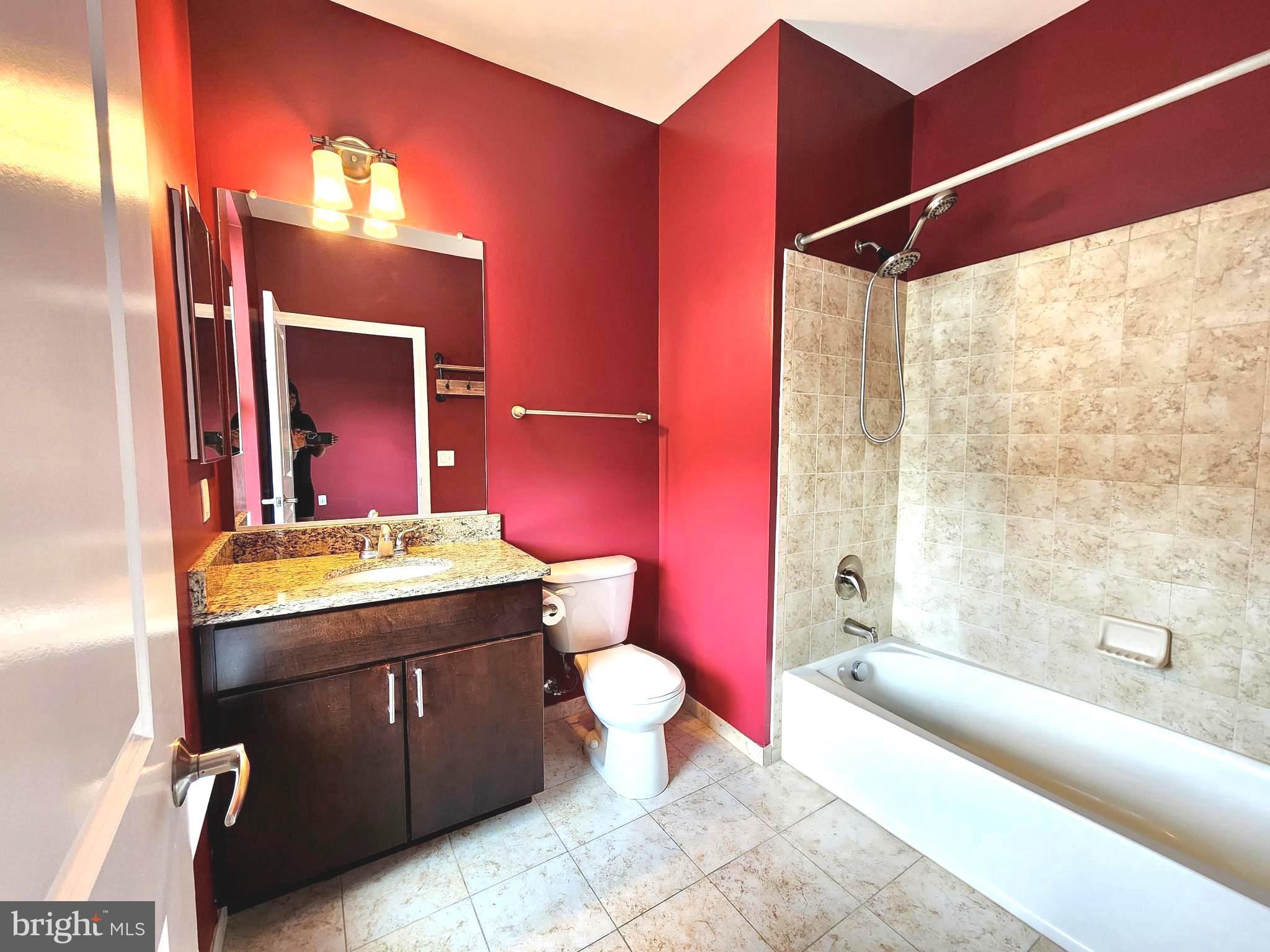2610 Sheridan Road Southeast, Unit 3 Washington, DC 20020 - Photo 11 of 30 a bathroom with a granite countertop sink and a mirror