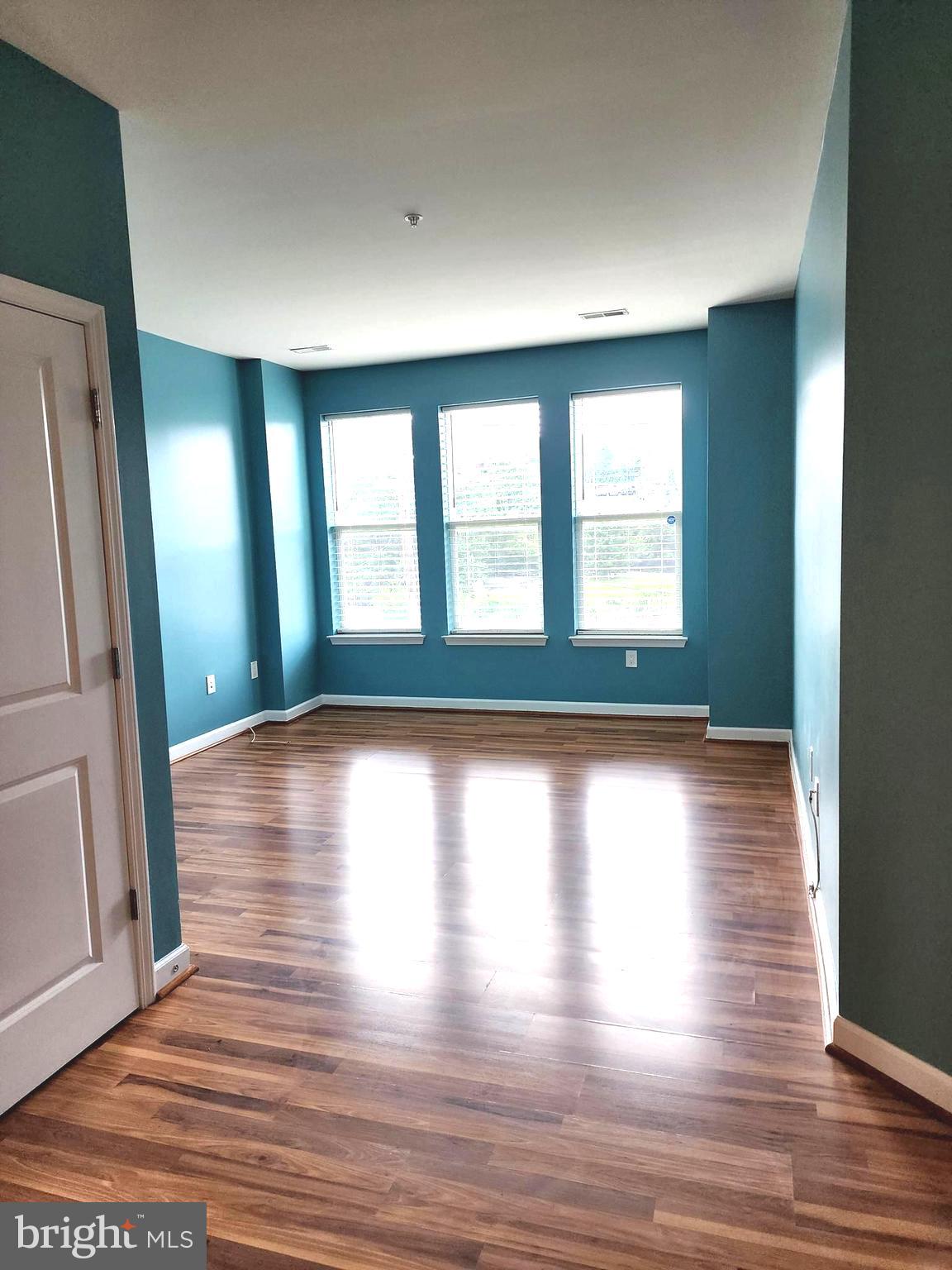 2610 Sheridan Road Southeast, Unit 3 Washington, DC 20020 - Photo 2 of 30 a view of empty room with wooden floor and fan