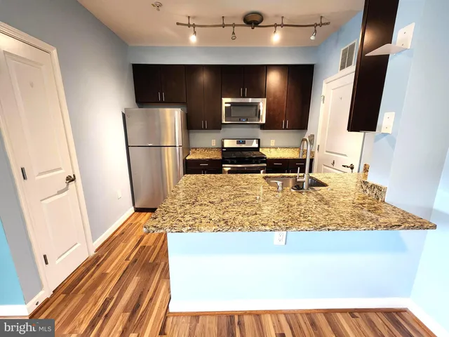 a kitchen with a sink stove and refrigerator