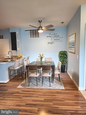 a view of a dining room with furniture and wooden floor