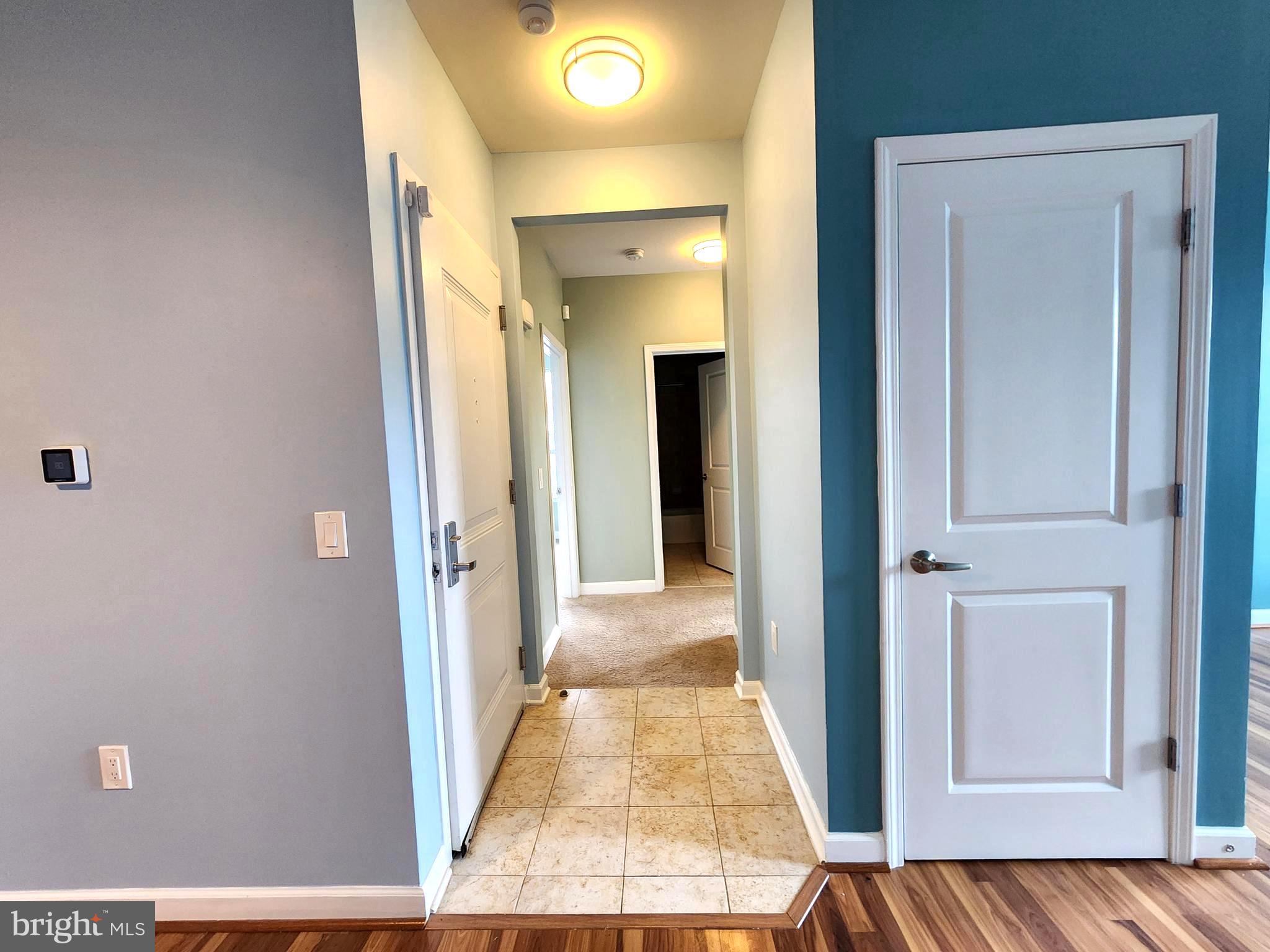 2610 Sheridan Road Southeast, Unit 3 Washington, DC 20020 - Photo 8 of 30 a view of a hallway with wooden floor and living room