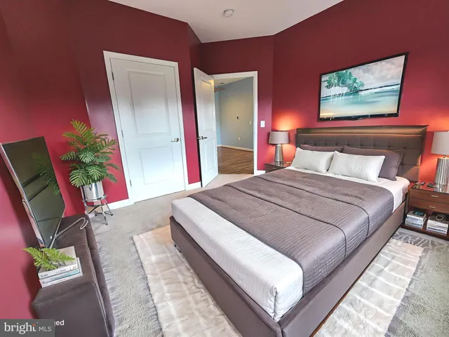 a bedroom with bed and a potted plant