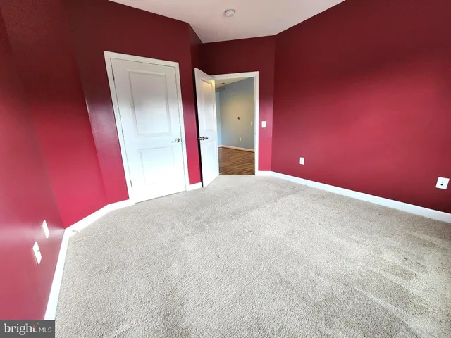 a view of a big room with closet and mirror
