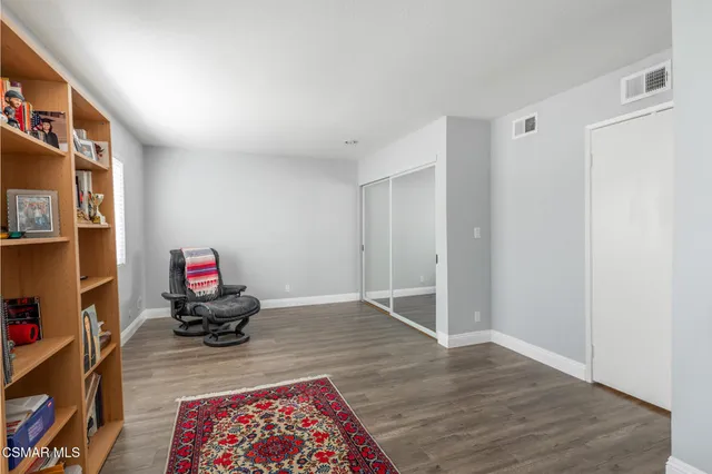 a living room with furniture and a book shelf