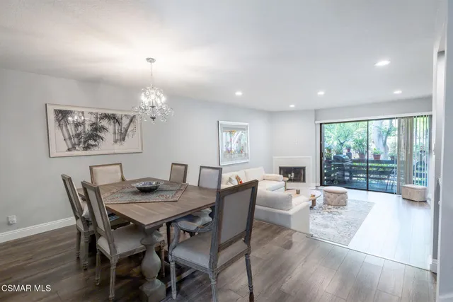 a view of a dining room with furniture wooden floor and a chandelier
