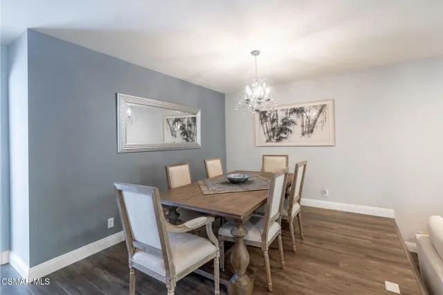 a view of a dining room with furniture wooden floor and a chandelier