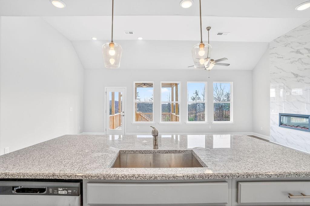 146 Wild Turkey Pass Homer, GA 30547 - Photo 12 of 38 a kitchen with granite countertop a sink cabinets and window