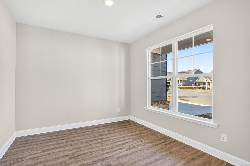 146 Wild Turkey Pass Homer, GA 30547 - Photo 6 of 38 a view of an empty room with wooden floor and a window
